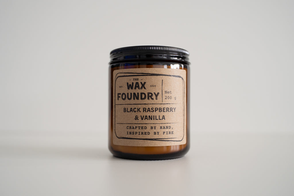 Candle jar with 'The Wax Foundry' label on a light gray background