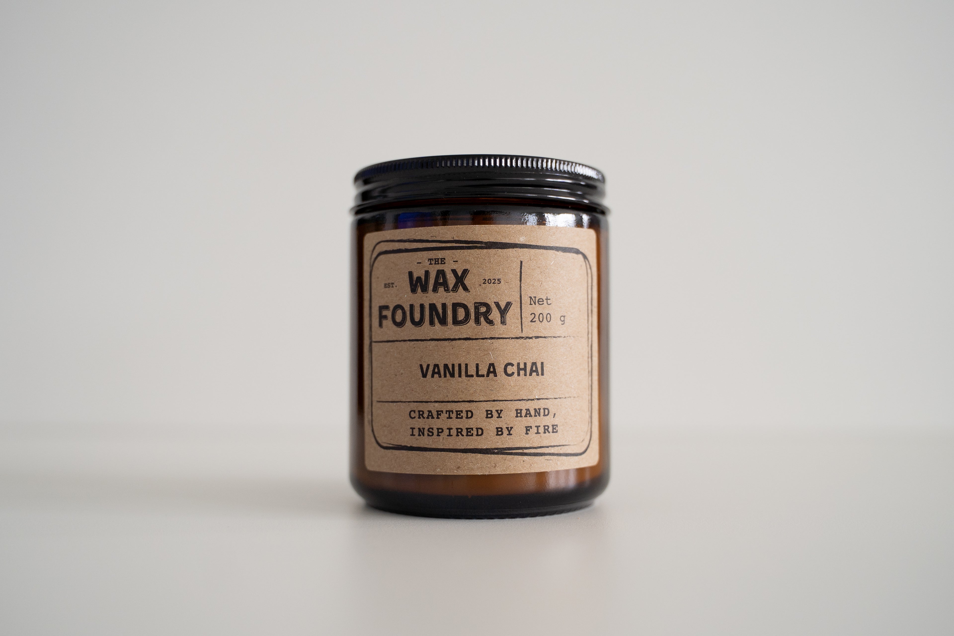 Candle from The Wax Foundry with 'Vanilla Chai' label on a light gray background