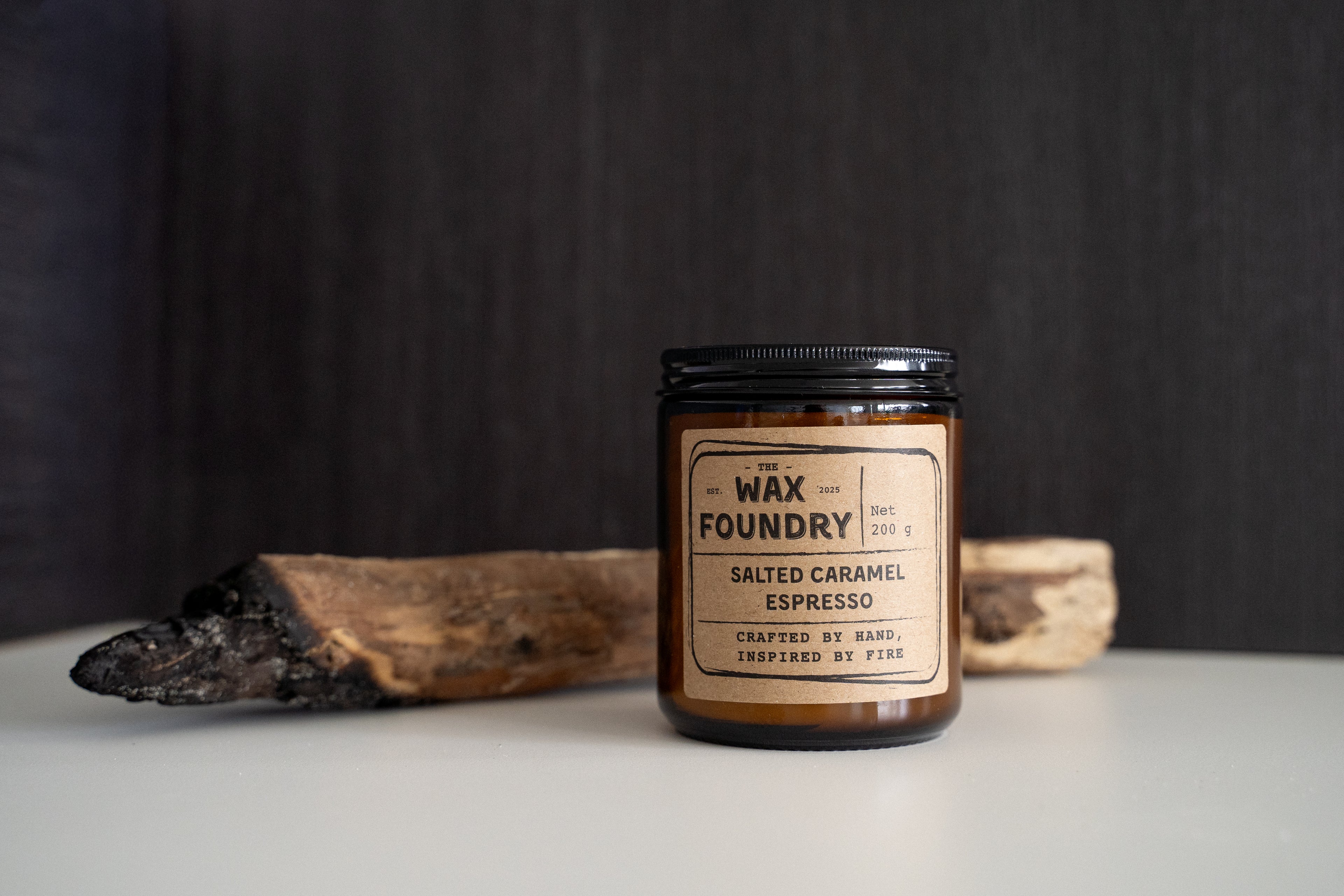 Wax Foundry candle with a wooden stick on a dark background
