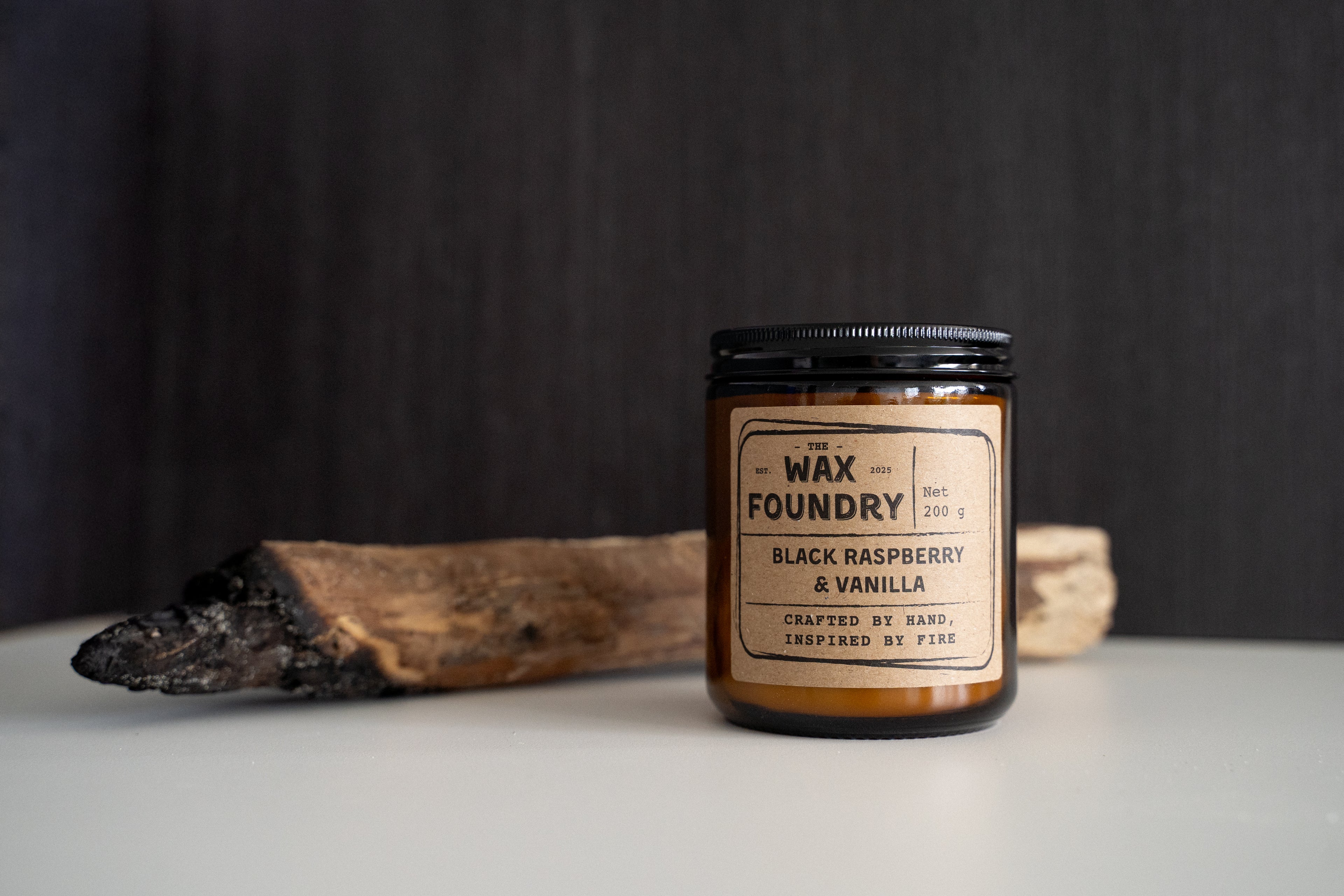 Wax Foundry candle with a label on a dark background